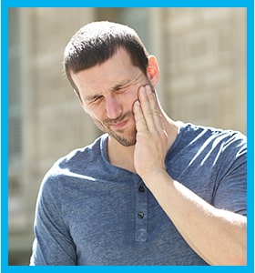 man suffering from TMJ, jaw pain